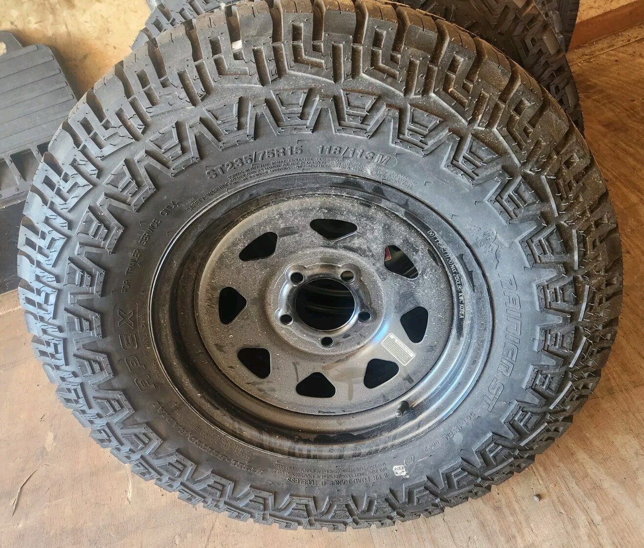 15″ 5LUG ON 4.5 STEEL WHEEL RAINER 235/75R15 8 PLY LOAD RANGE D