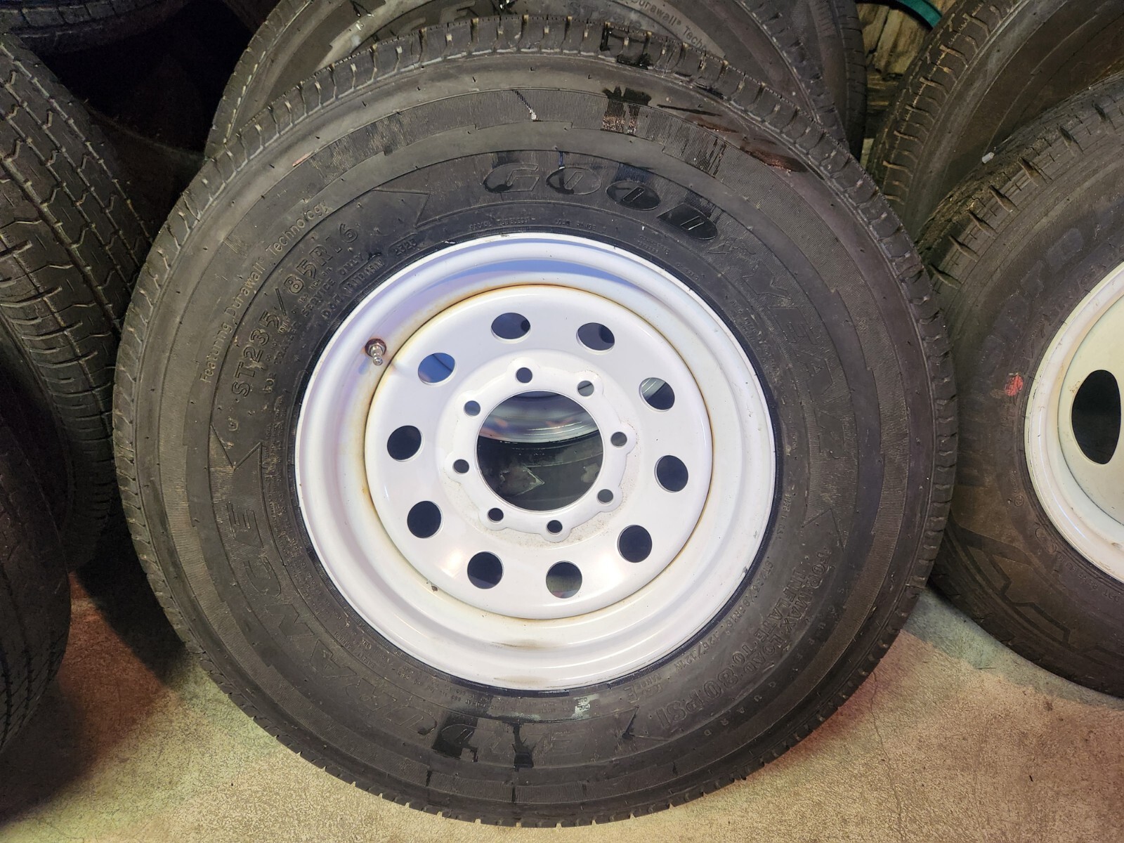 16″ 8 LUG ON 6.5 STEEL WHEELS & 235/85/16 10 Ply GOOD YEAR – WHITE